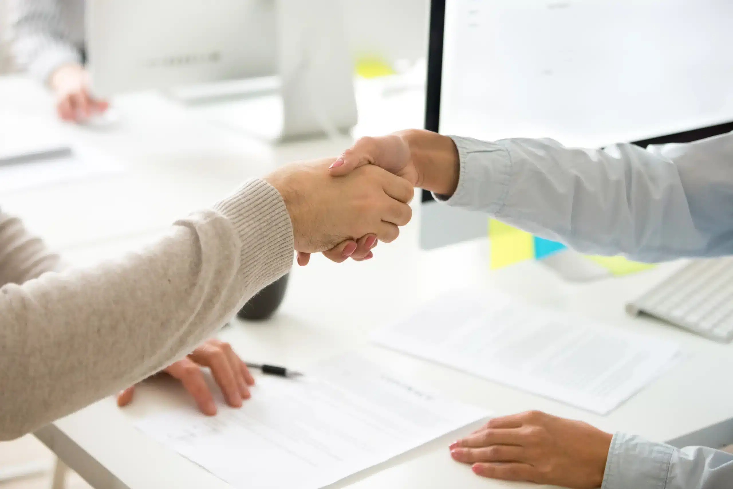 Business handshake representing Arvia Solutions trusted partnership and professional service delivery across Malaysia