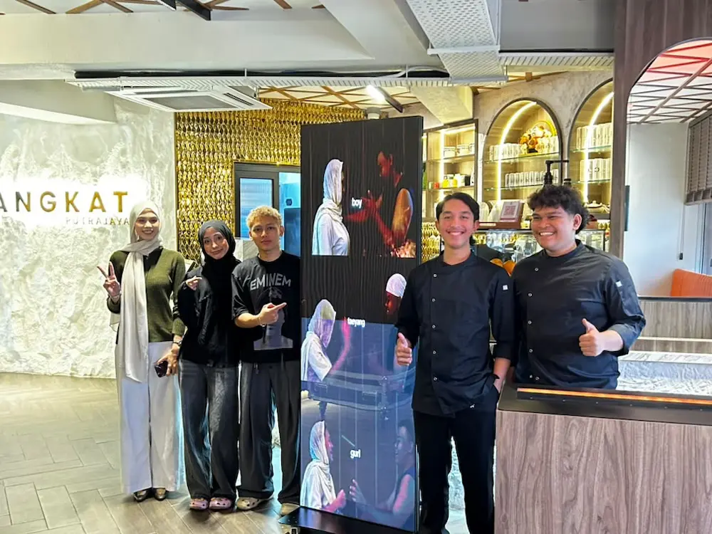 Changkat Cafe team with the Arvia LED poster for cafe displaying promotions in Putrajaya