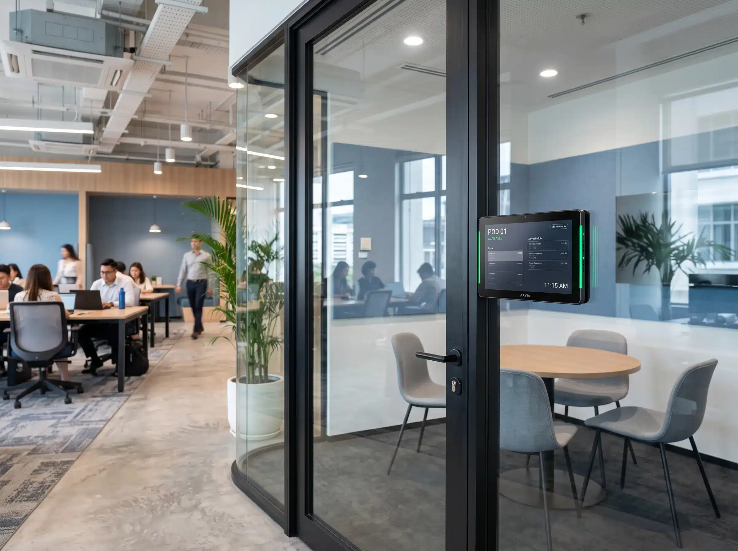 Arvia meeting room booking touchscreen outside a glass meeting pod in a Malaysian coworking space